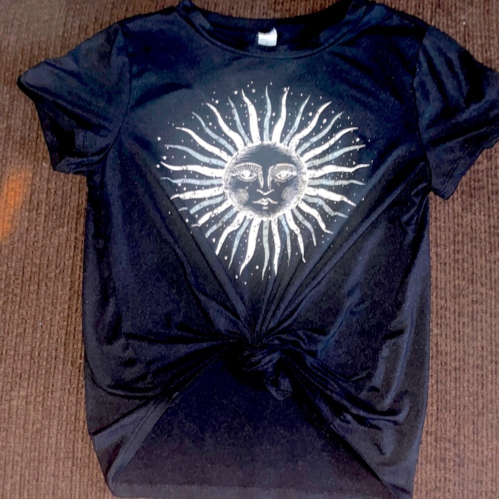 A black tee with a sun and tied in the front